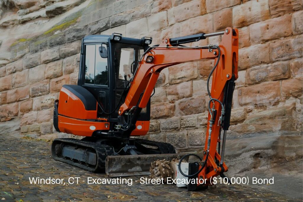 Windsor, CT - Excavating - Street Excavator ($10,000) Bond - Small excavator on sidewalk during repair works on street.