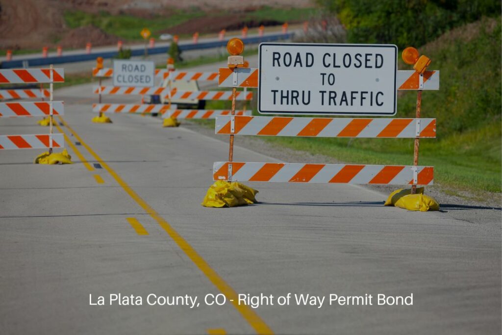 El Paso County, CO - Right of Way Permit Bond - Summer construction and road closed signs blocking the street.