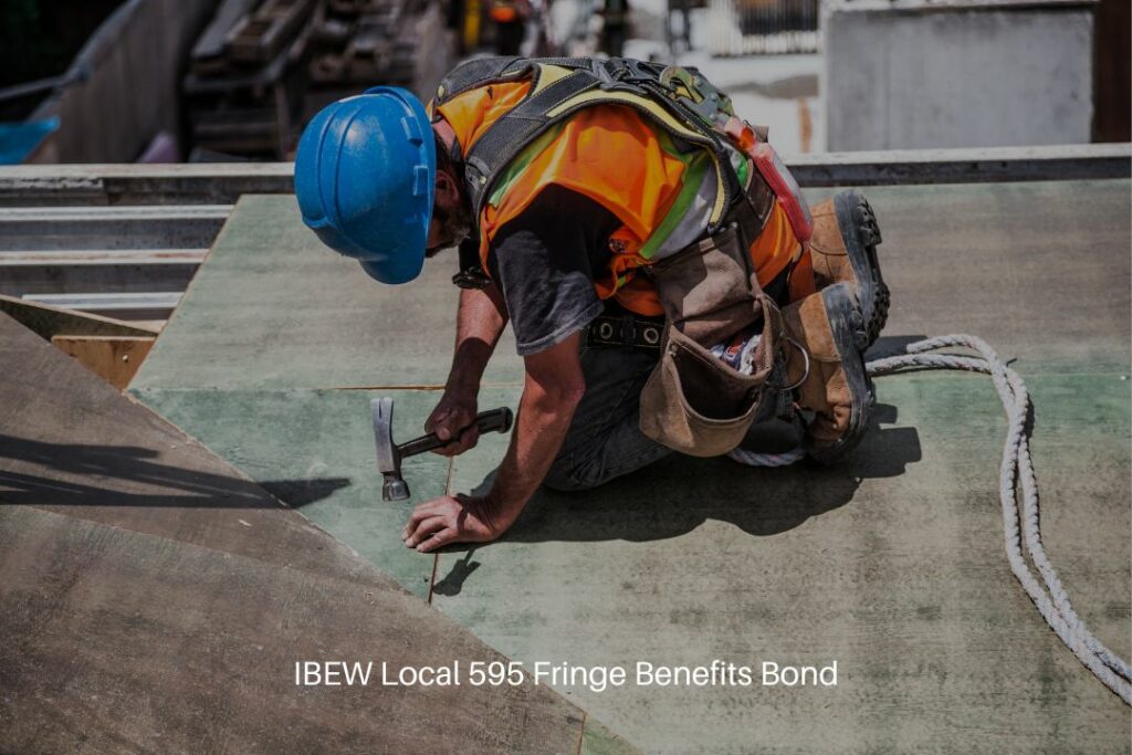 IBEW Local 595 Fringe Benefits Bond - Man wearing blue hard hat and using hammer in the construction site.