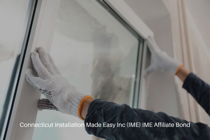 Connecticut Installation Made Easy Inc (IME) IME Affiliate Bond - Worker installing plastic window indoors.