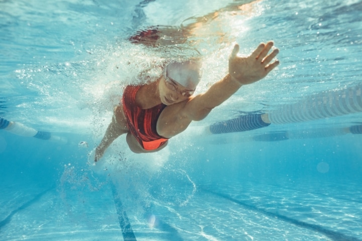 FL - Miccosukee Athletic Commission Promoter Bond - A female athlete swimming in pool.