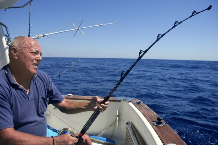 Glades County, FL - Game and Fish License and Permit Bond - Angler senior big game sport fishing boat.