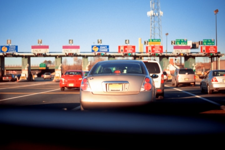 FL - Turnpike Toll - Sunshine State Parkway Bond - Car pulling into toll.