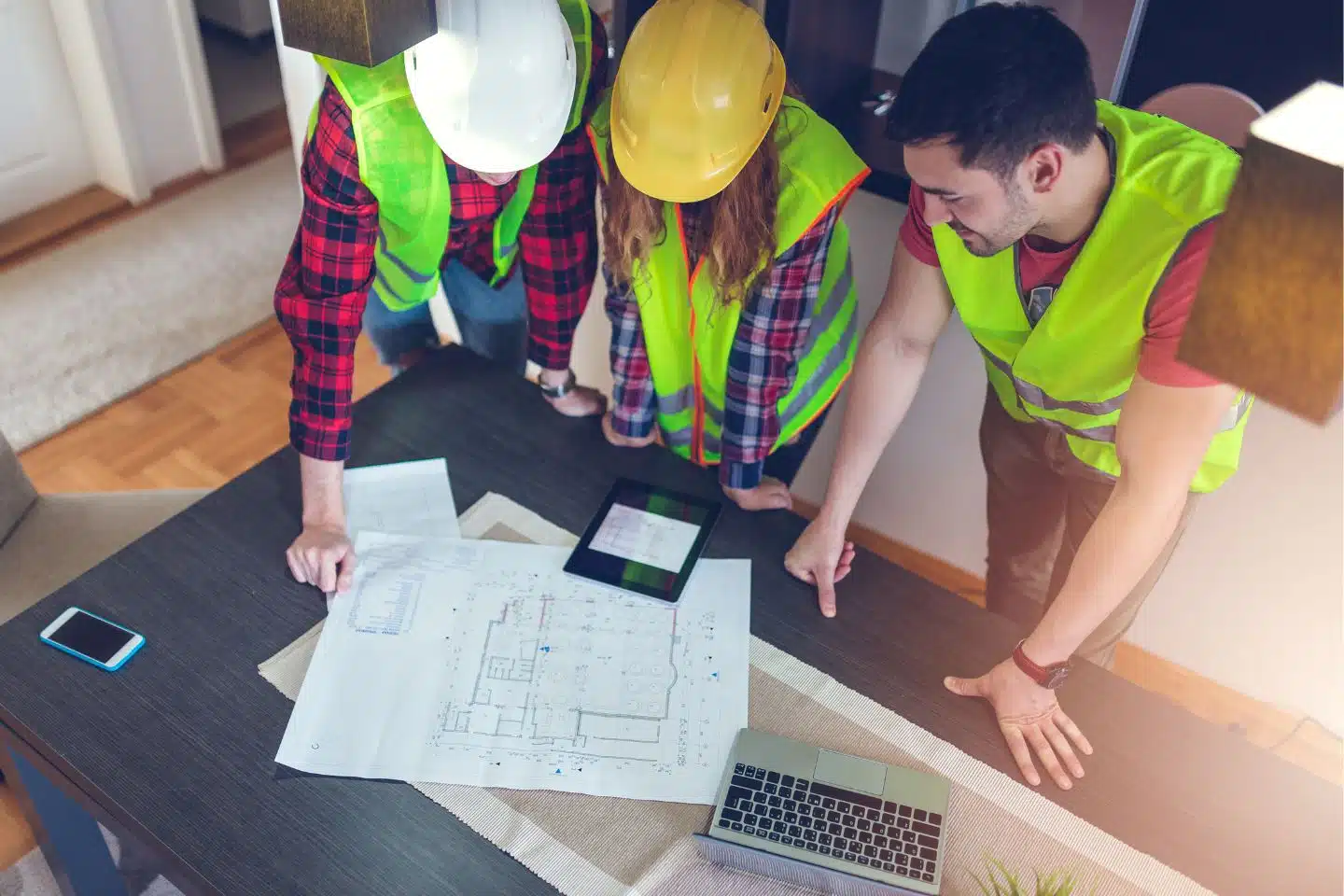 Windermere, FL - Contractors License Bond - Three construction workers looking at the blueprint.