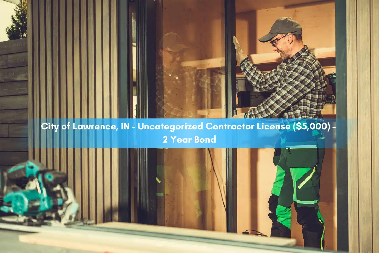 City of Lawrence, IN - Uncategorized Contractor License ($5,000) - 2 Year Bond - Contractor installing aluminum frame window glass doors inside.