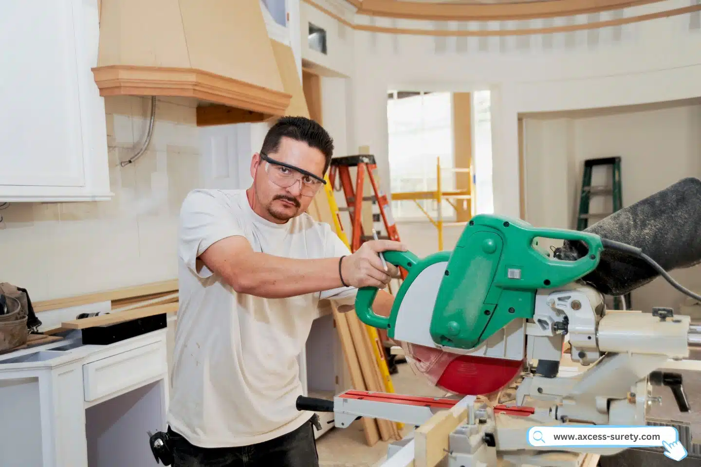 A finish carpenter uses a large miter saw to cut molding for a custom kitchen remodel.