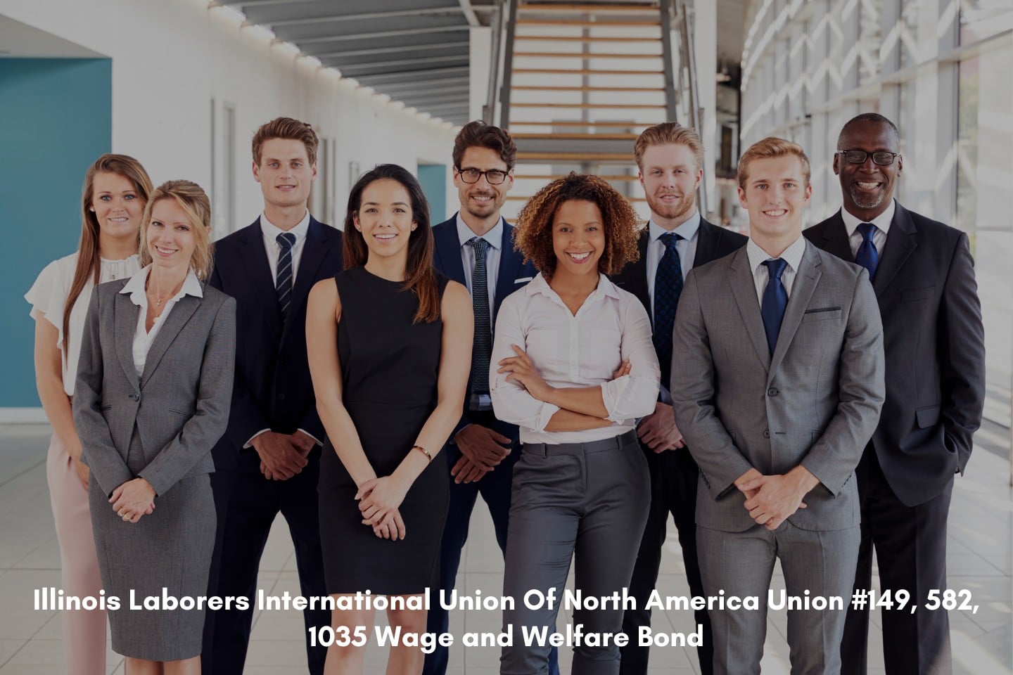 Young office workers standing together holding hands.