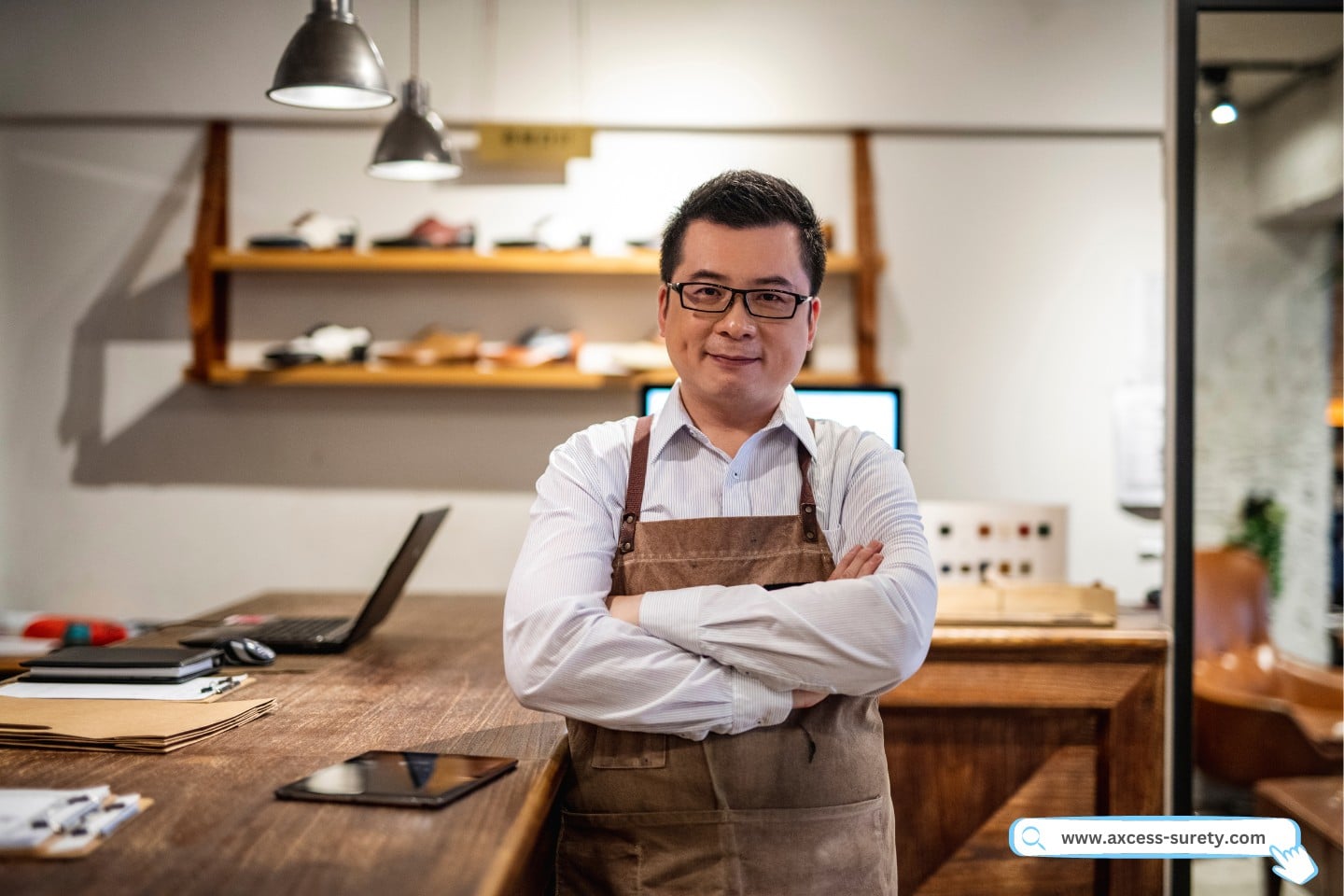 A portrait of successful shoe merchant standing behind the counter of his shoe store for men.