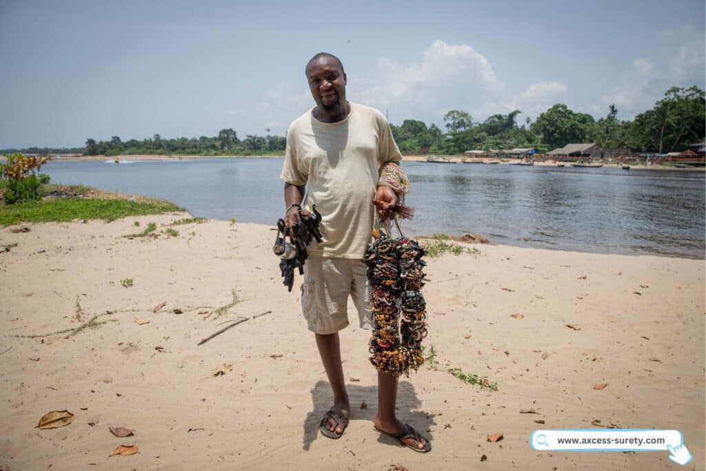 African bracelet vendor offering all of his individually made bracelets for sale.
