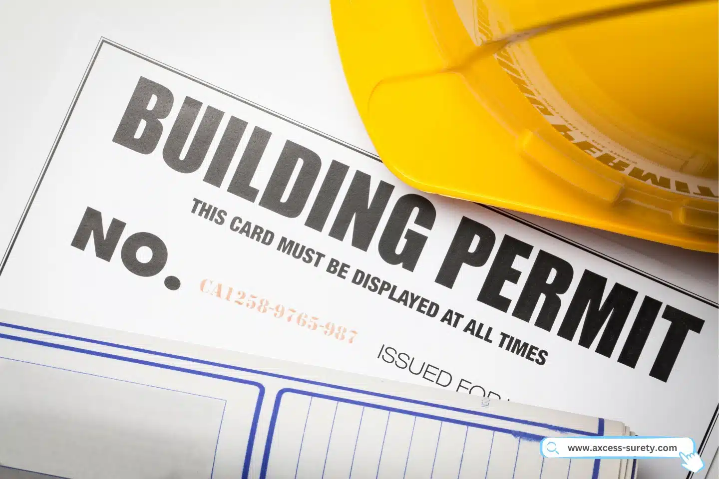 Building permit, blueprint, yellow hard hat.