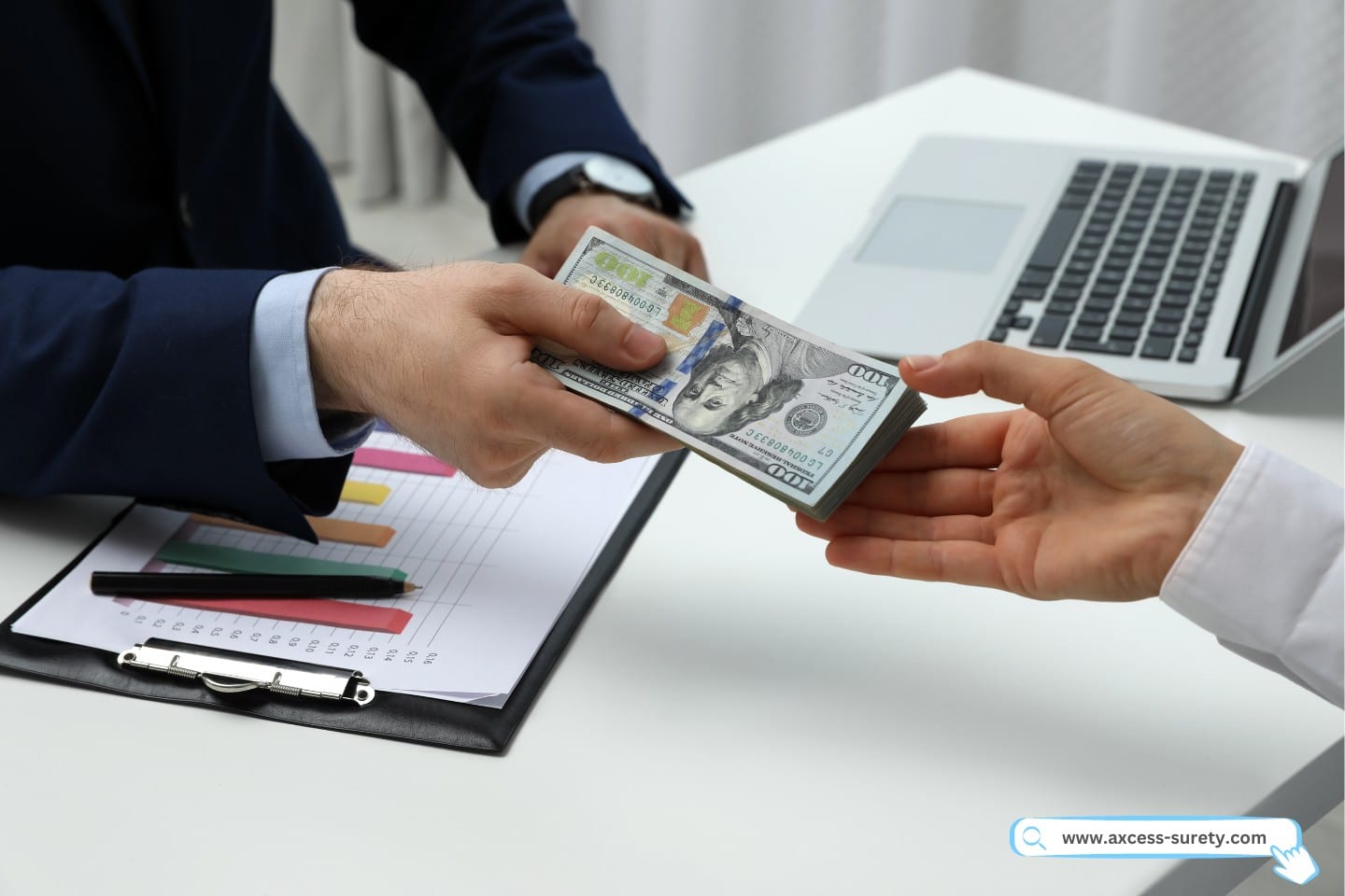 A bank teller handling dollars to a clients hand.