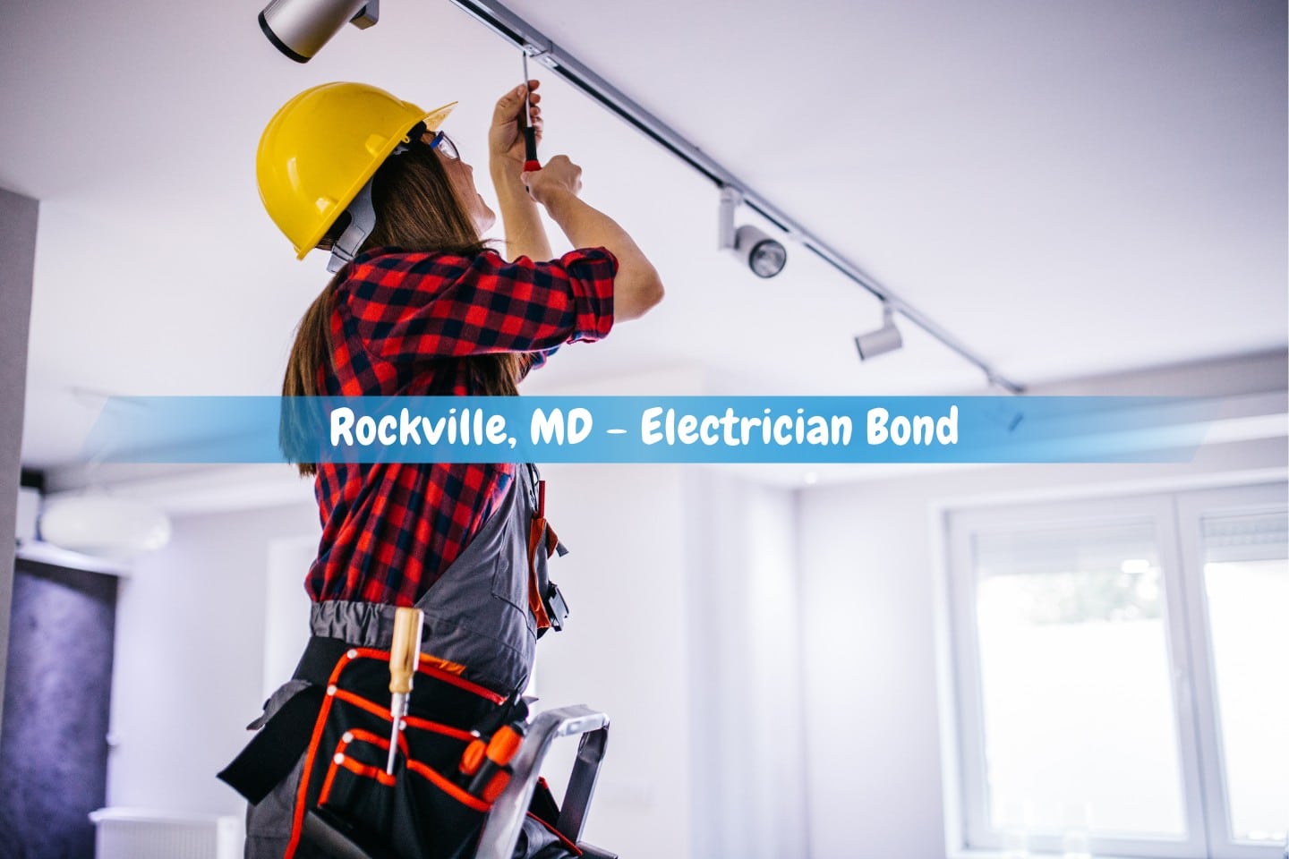 Rockville, MD - Electrician Bond - Female electrician installing new lights rail on a residential place.