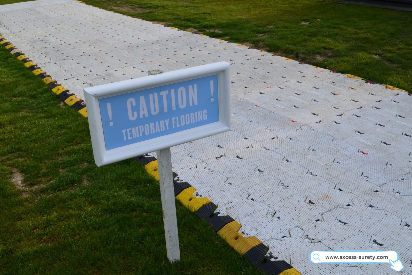 Notice indicating that the moist ground is temporarily covered with a temporary floor.