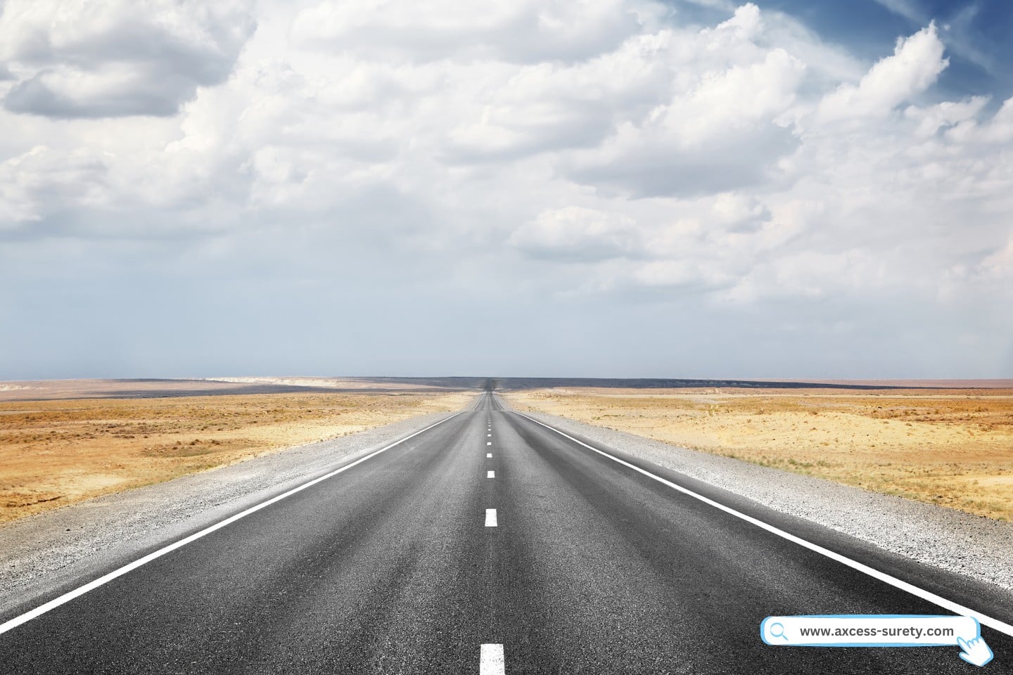 A long highway with a desert around it.