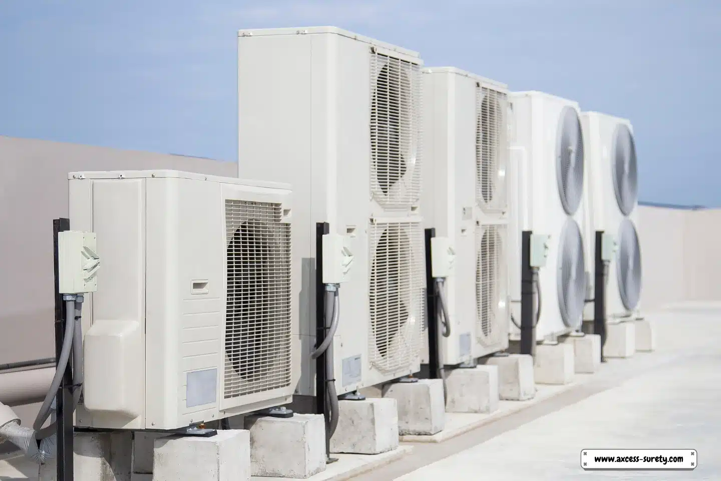 The industrial building has air conditioning (HVAC) installed on its roof.