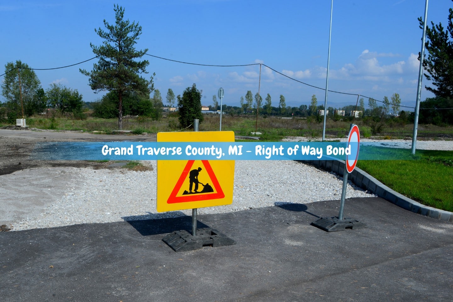 Grand Traverse County, MI - Right of Way Bond - A road works sign indicates that construction is taking place on the street.