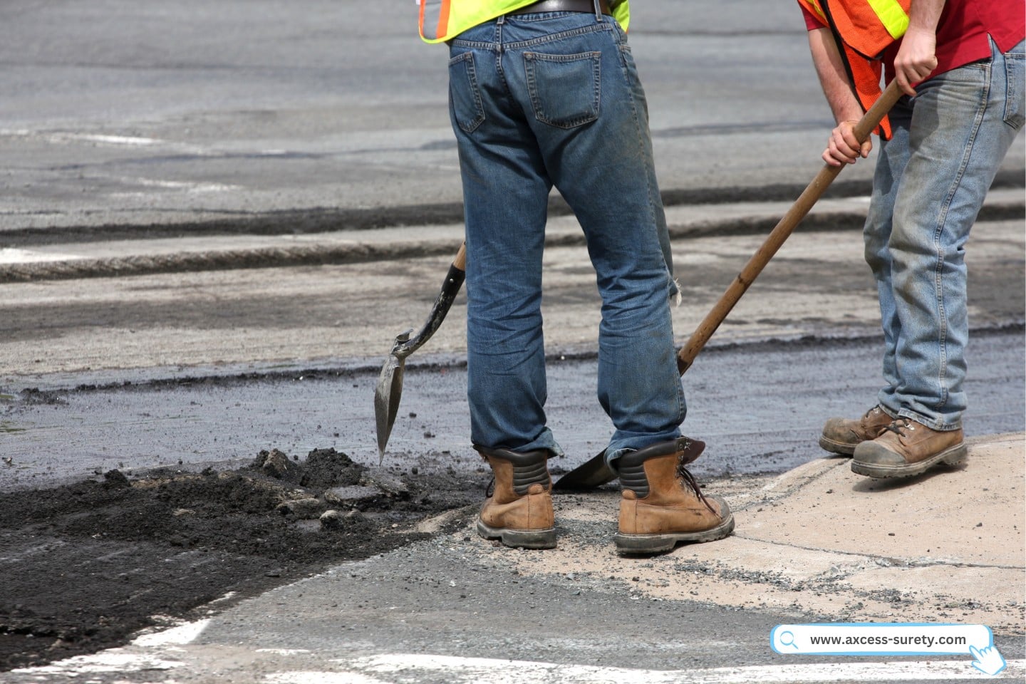 Shovels are used by road construction workers to remove fractured asphalt chunks from a road rehabilitation project.