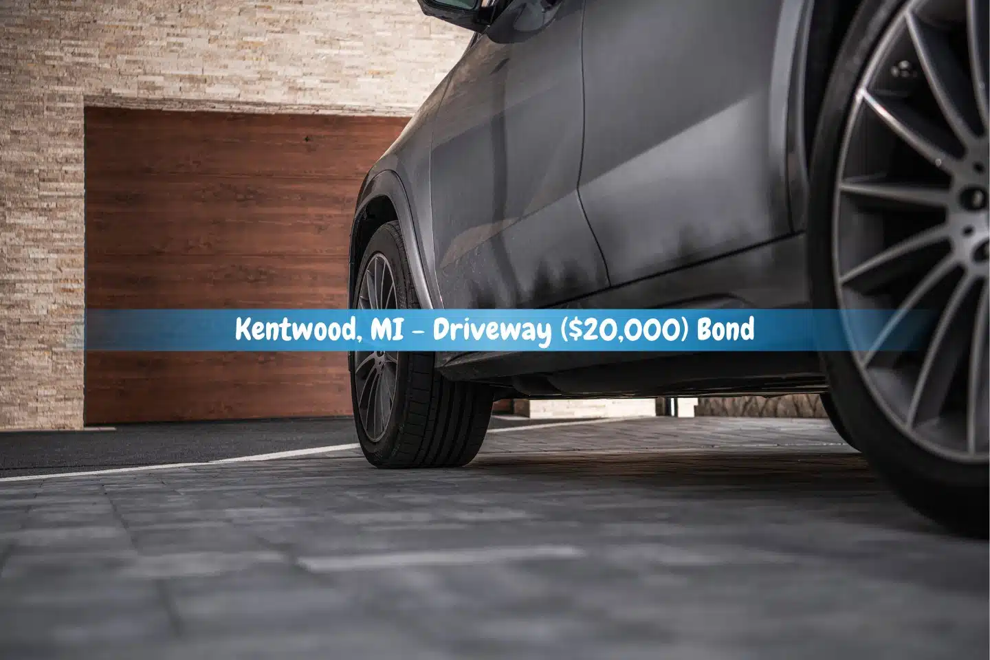Kentwood, MI - Driveway ($20,000) Bond - A contemporary crossover vehicle is parked in the driveway in front of the house's built-in garage.