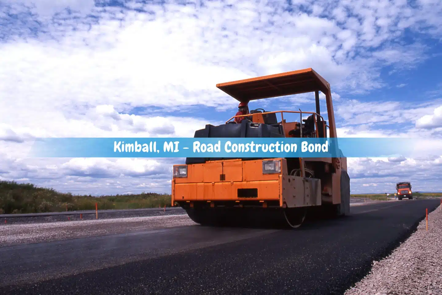 Kimball, MI - Road Construction Bond - A construction flattener works with fresh asphalt on a road construction site.