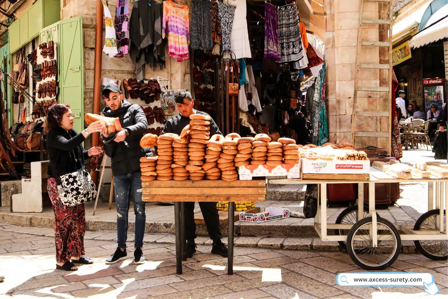 In the street, a woman was making purchases from two street vendors.