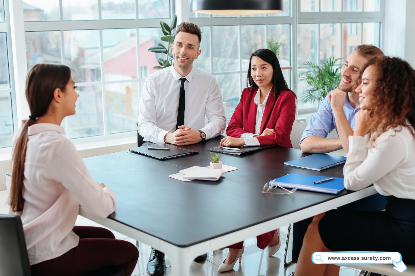 A woman is interviewed in the office by the human resources commission.