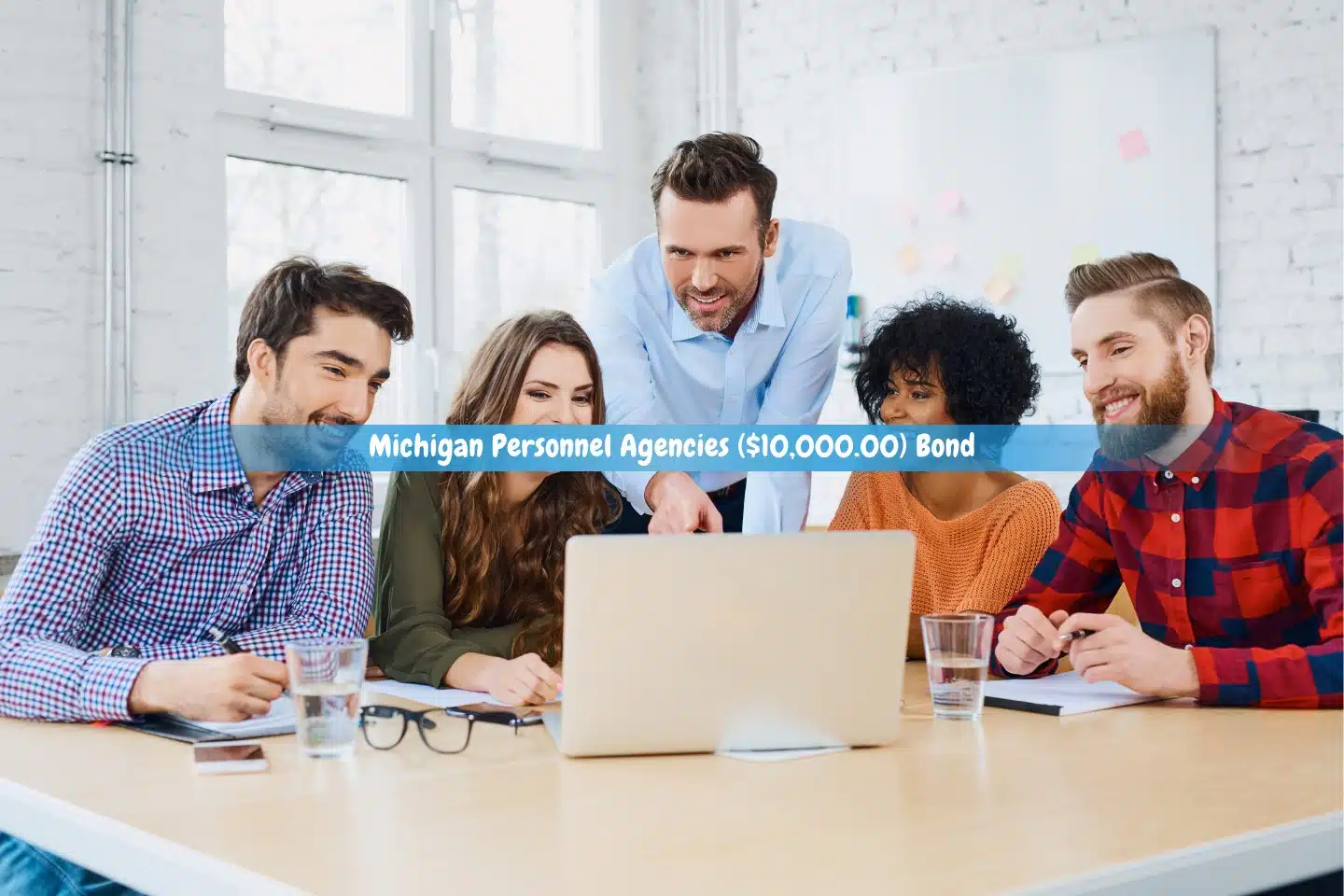Michigan Personnel Agencies ($10,000.00) Bond - Coworkers at the agency are using laptops to discuss new strategies.