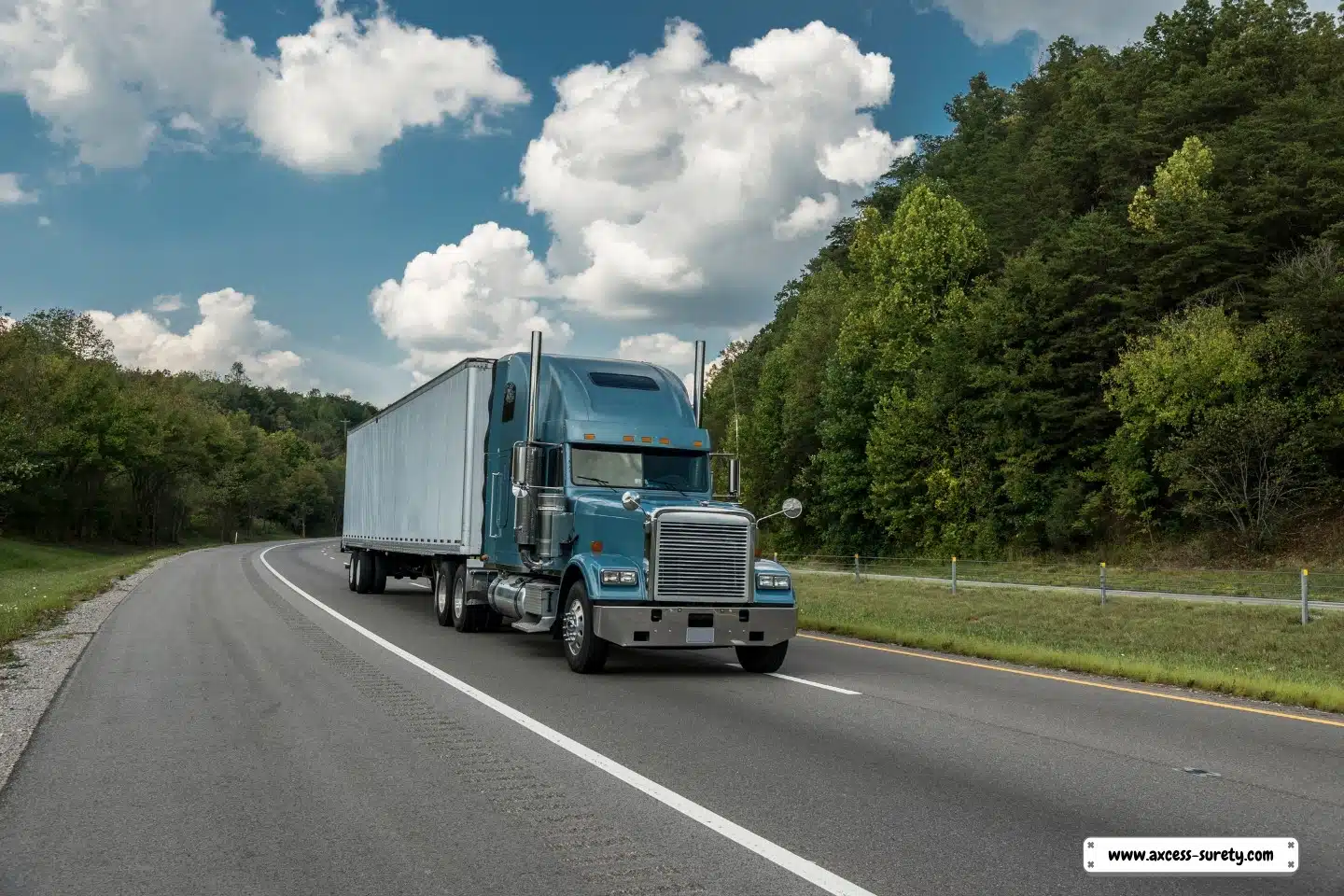 An interstate roadway with a single blue semi-truck.