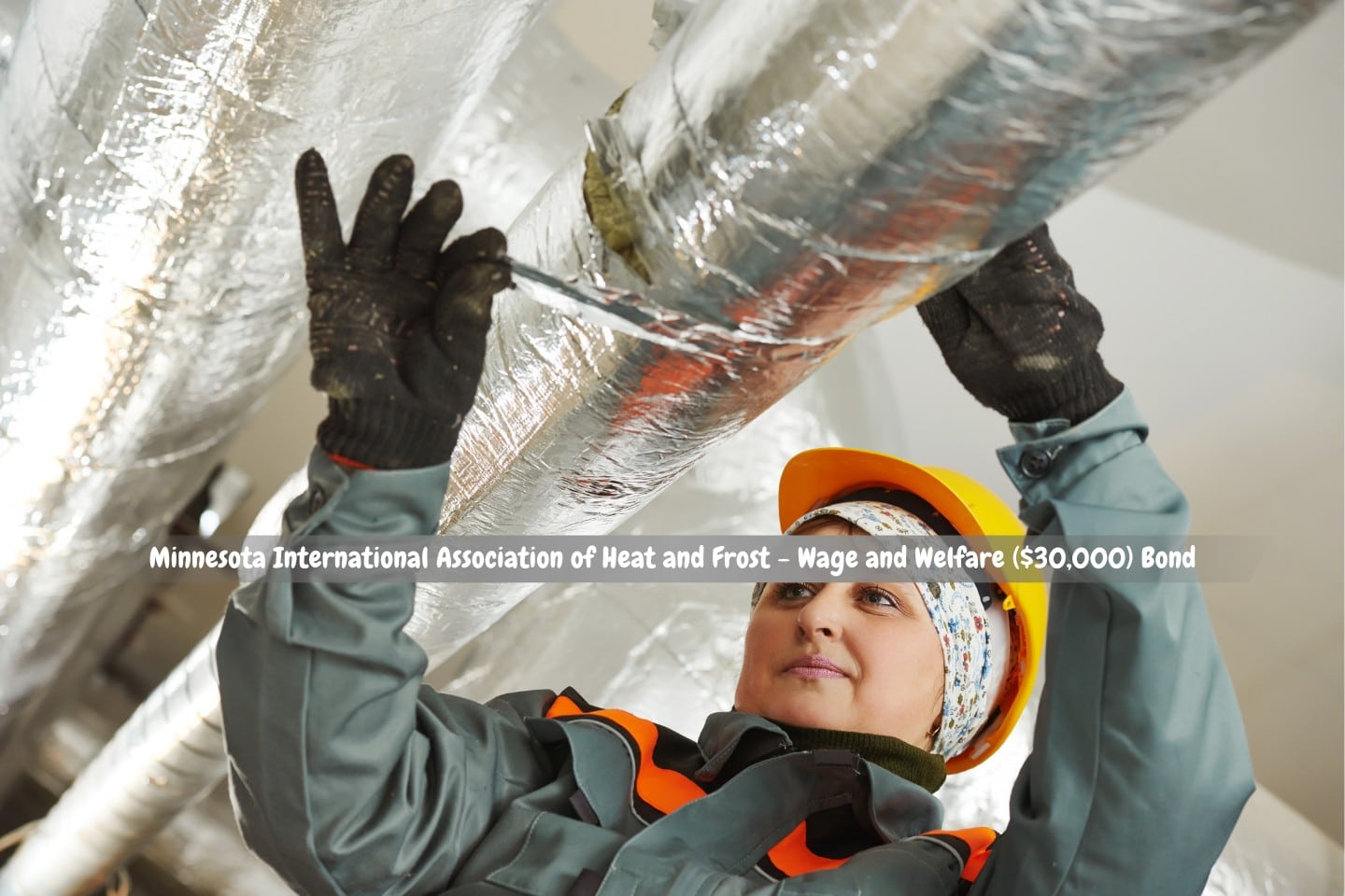 Minnesota - International Association of Heat and Frost - Wage and Welfare ($30,000) Bond - A female insulation worker uses foil and glass wool to isolate industrial pipes.