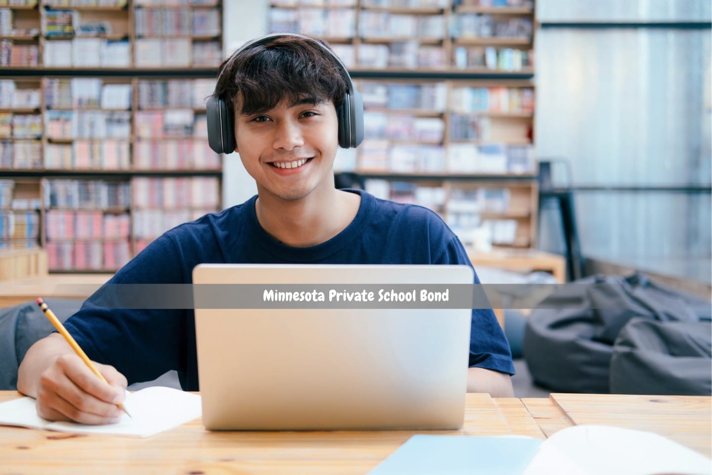 Minnesota Private School Bond - A young college student uses a laptop to study in the library.