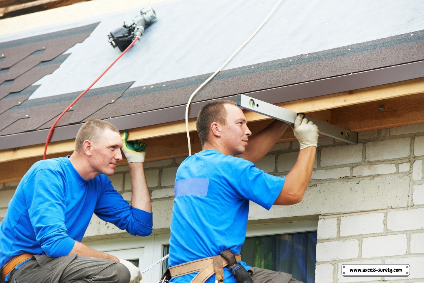 A worker on the roof installs roofing using flex tile material.