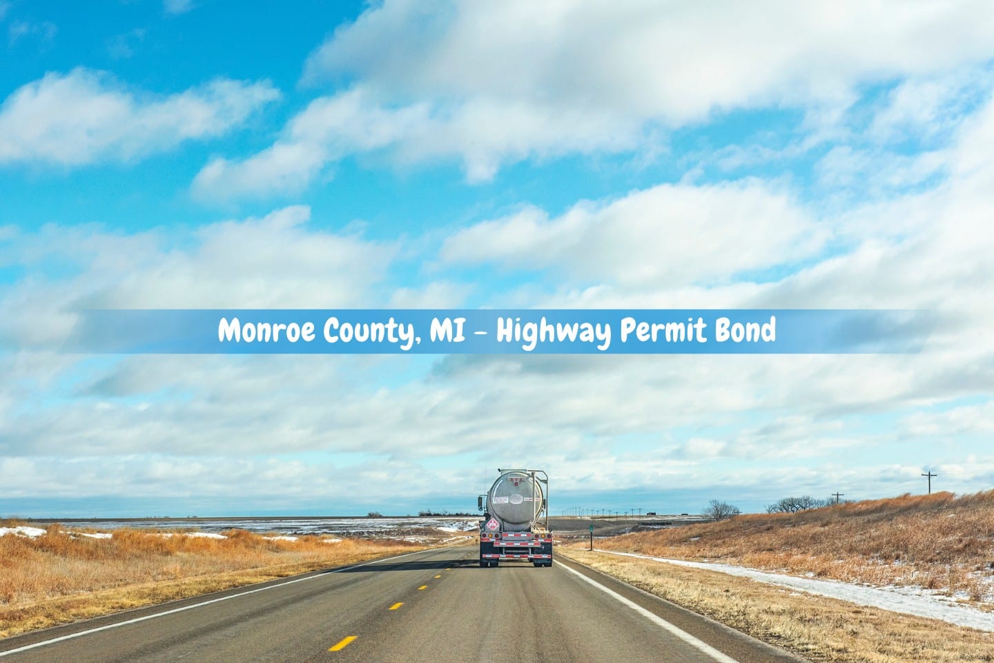 Monroe County, MI - Highway Permit Bond - A single truck drives off into the distance on a rural highway.
