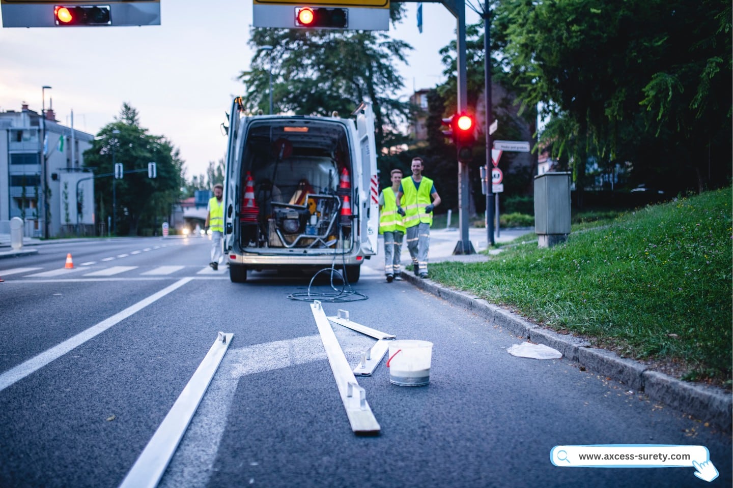 A construction worker wearing fluorescent vests walks from a utility vehicle to a turn arrow that will be spray painted.