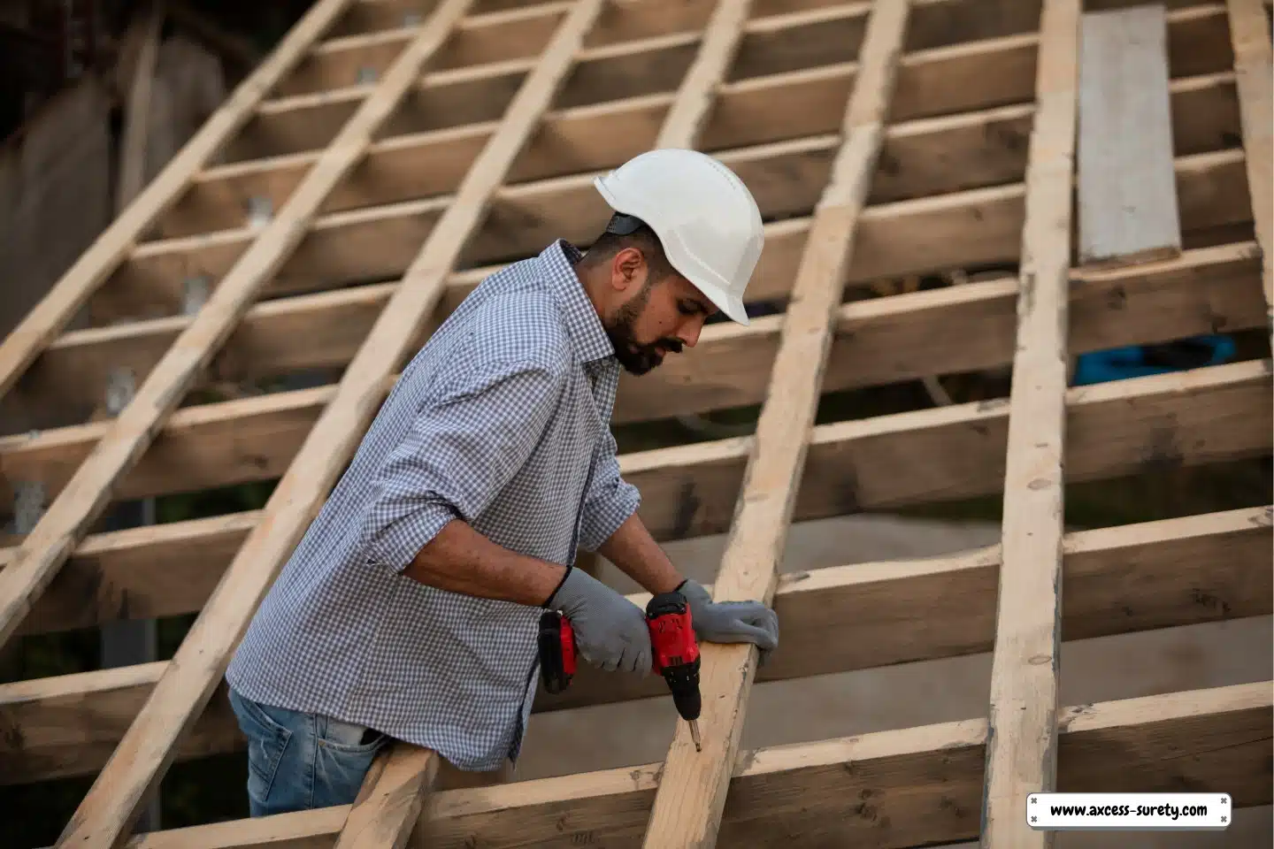 A man wearing his white hard hat on a construction site.