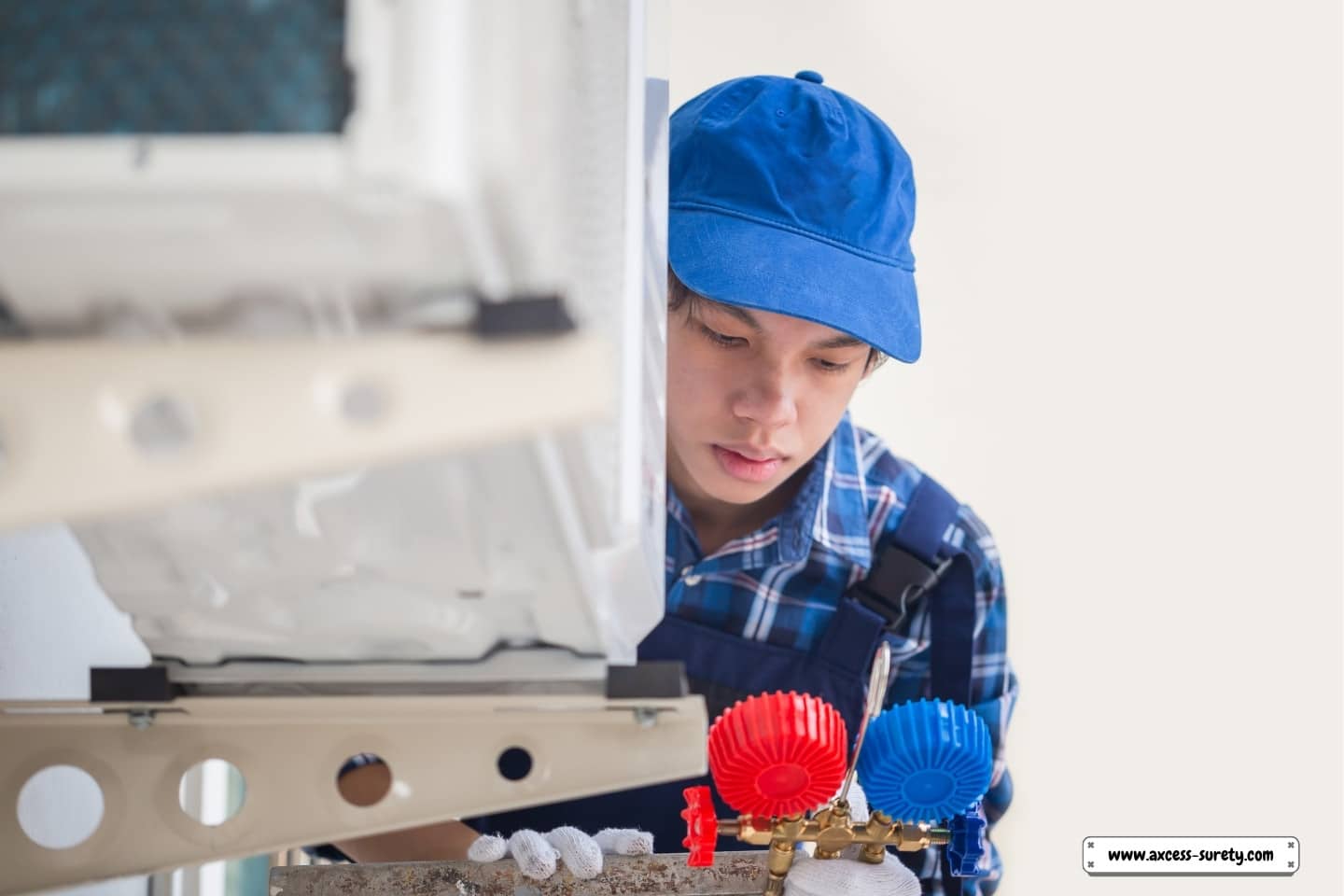 A technician inspects a residential home's air conditioning system.