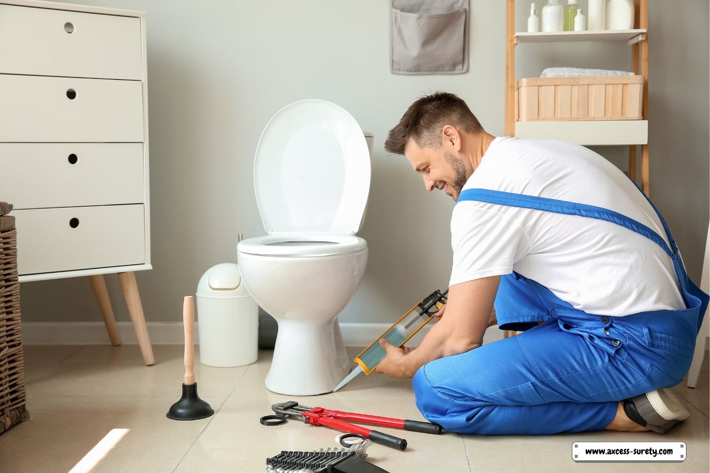 A blue-uniformed plumber is working in a shower stall.