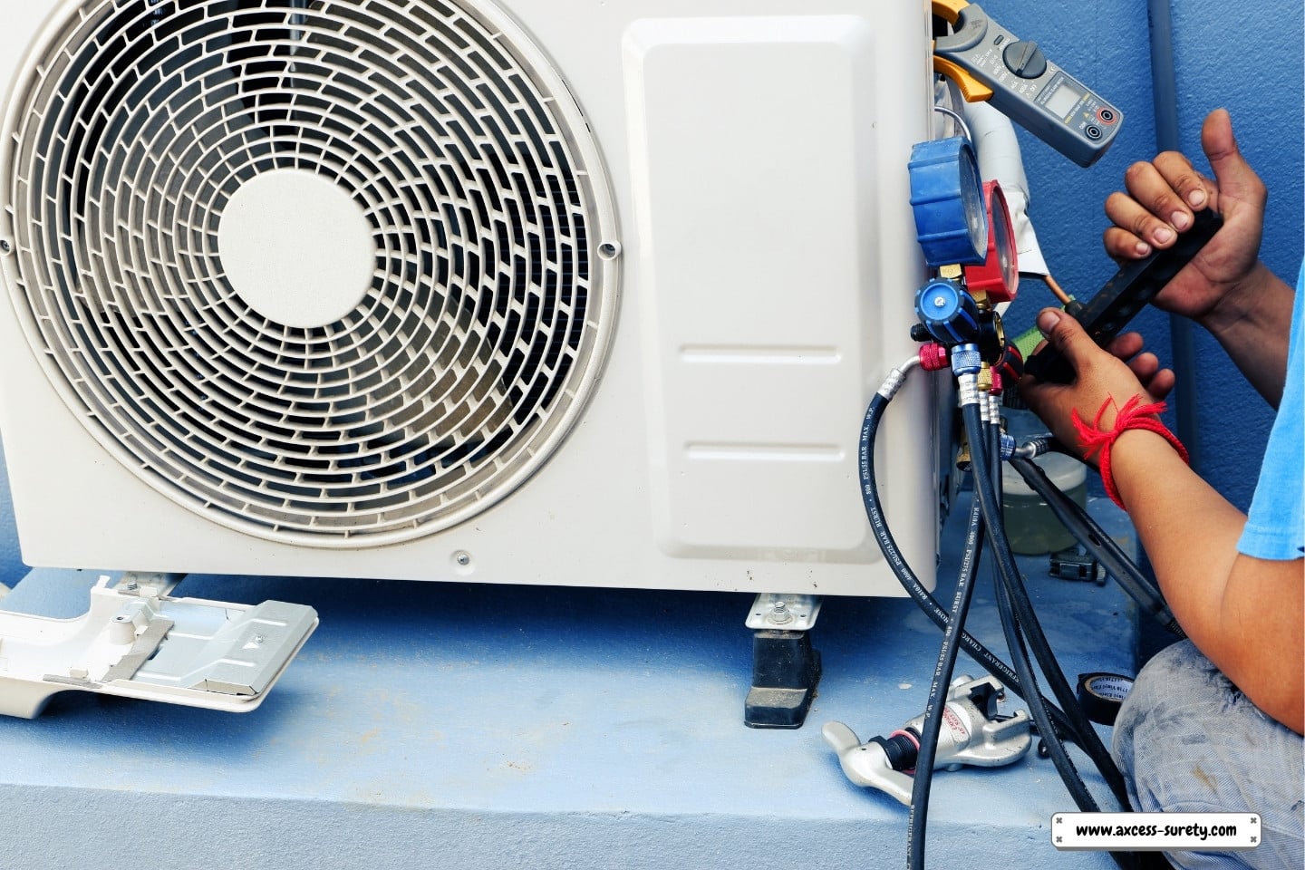An air conditioner is being repaired by an air conditioning expert.