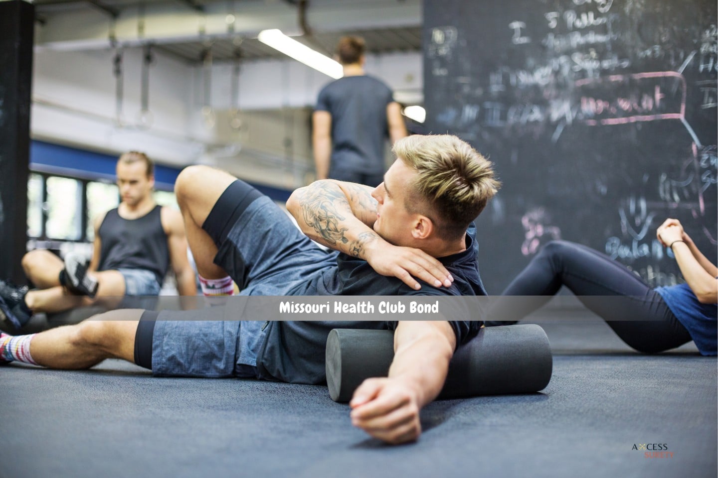Missouri Health Club Bond - At the health club, a man is rolling on a foam roller.