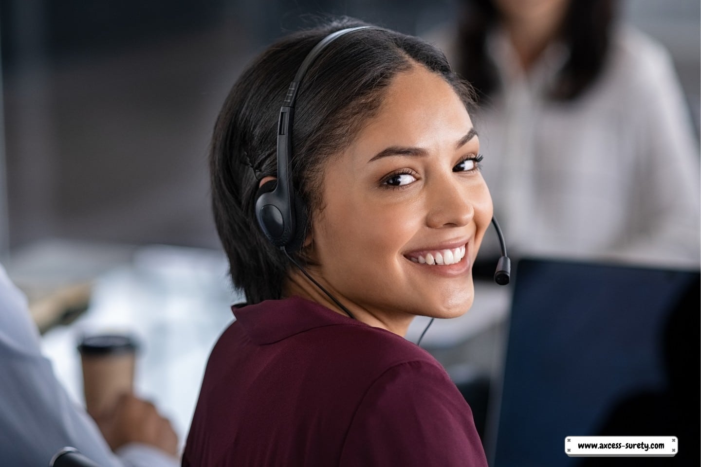 In the contact center, a female collection agent is wearing a headset.