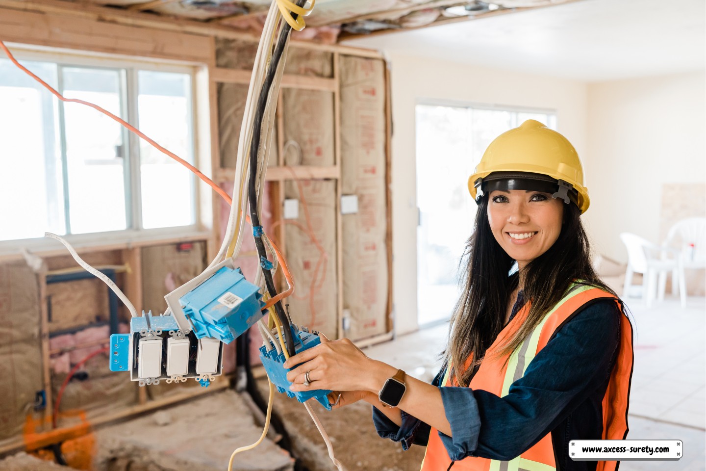 At the building site, a woman is inspecting the electrical wiring.