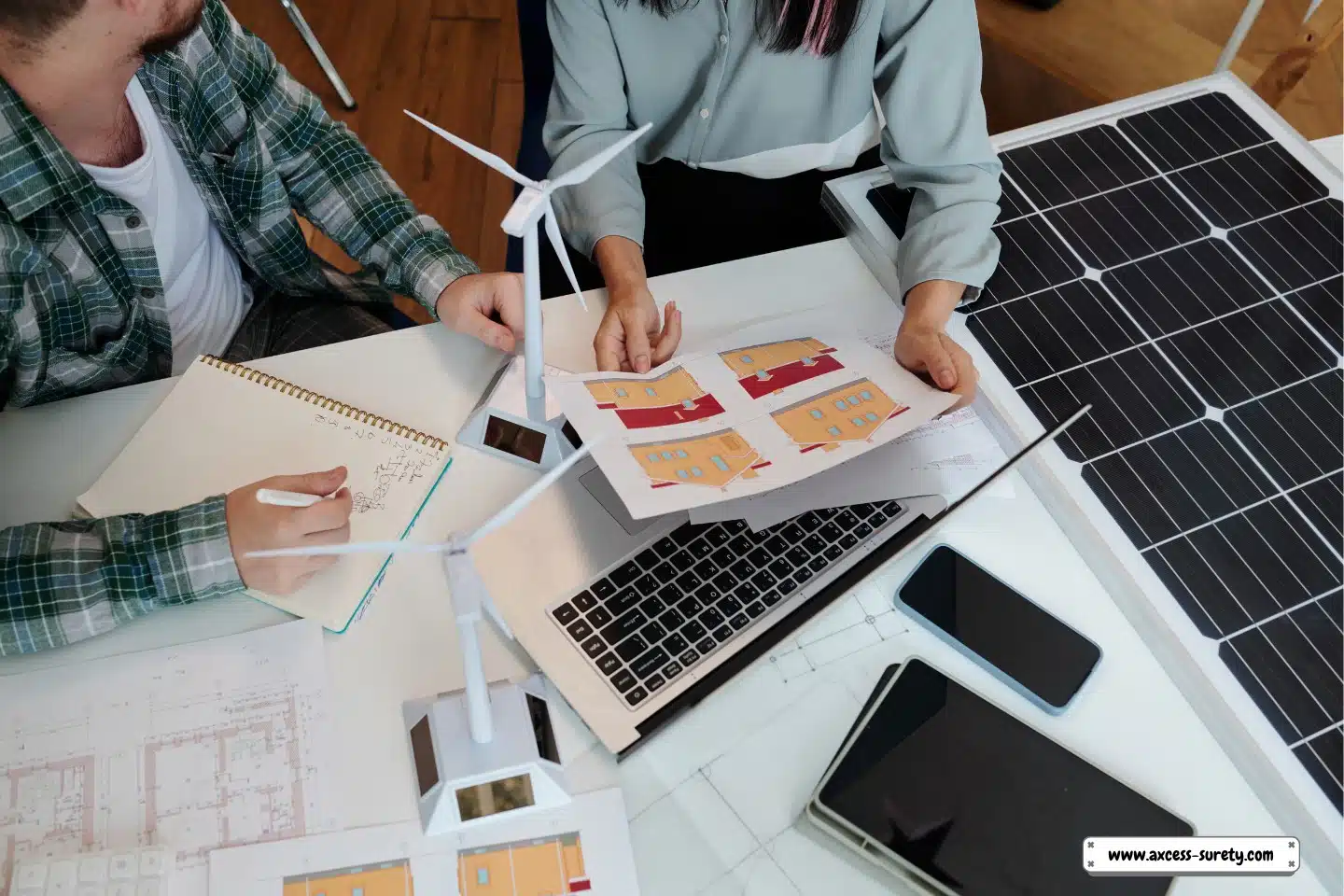 A solar energy engineer assists a client in discussing a home improvement proposal.