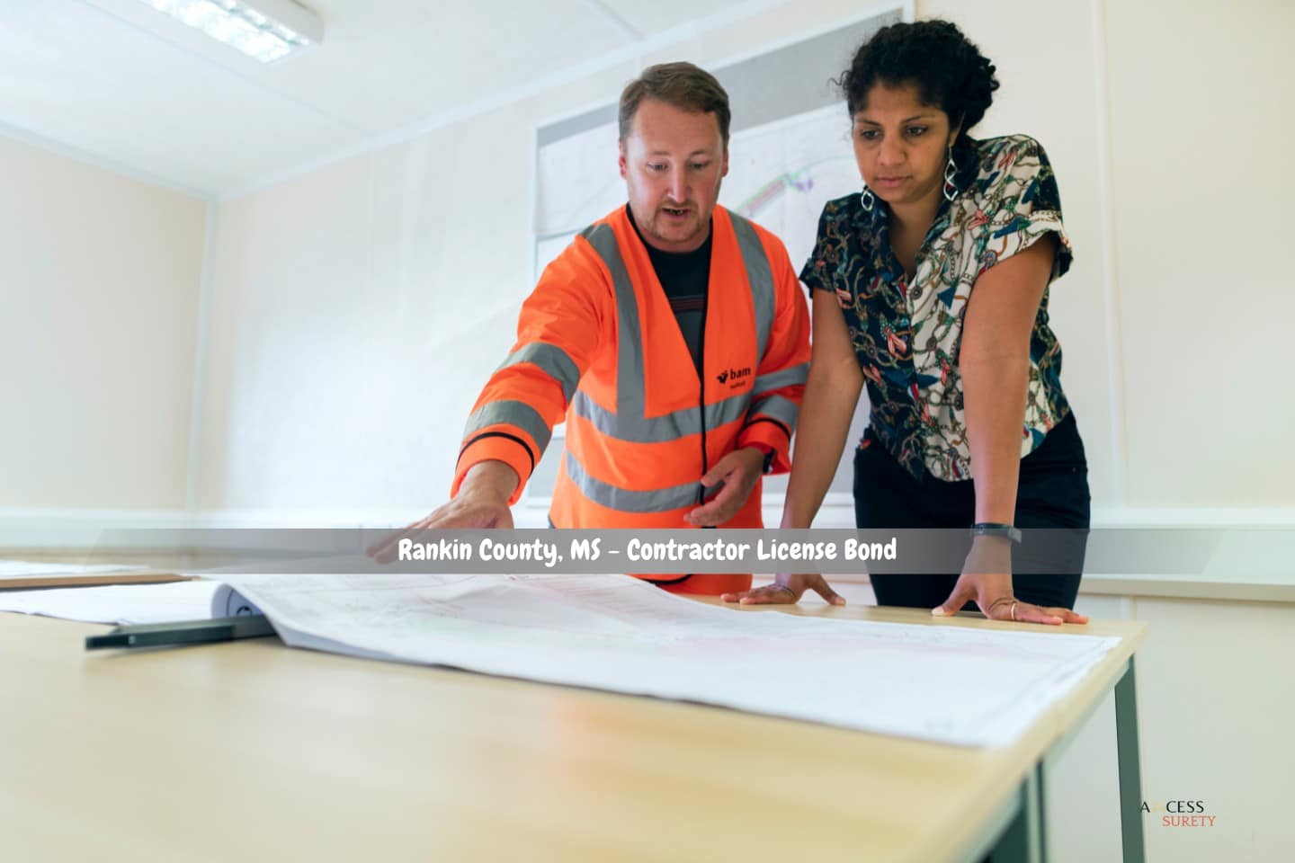 Rankin County, MS - Contractor License Bond - A client and an engineer are examining the house's ongoing blueprint.