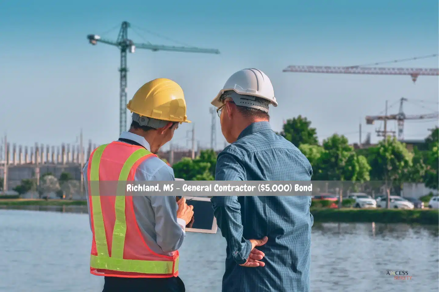 Richland, MS - General Contractor ($5,000) Bond - On a real estate development site, two engineers and workers are having a tablet conversation.
