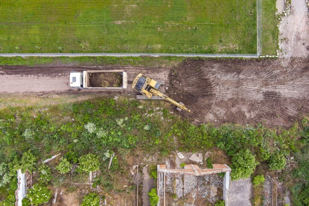 aerial-view-of-an-excavator-working-removing-earth-2023-11-27-04-51-05-utc_11zon