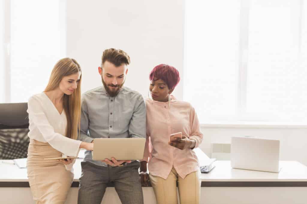 colleagues-using-laptop-together