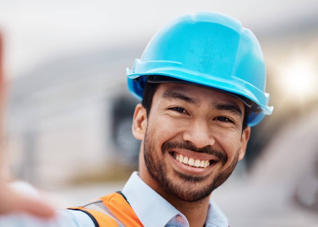 Construction worker, selfie and portrait with helmet outdoor of builder and maintenance employee. H.