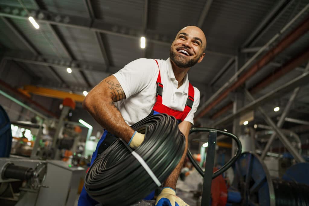 Portrait of a smiling handsome african american factory worker, close up