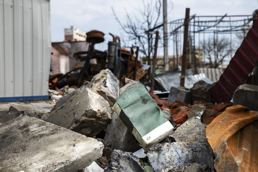 a pile of rubble with a green object on top