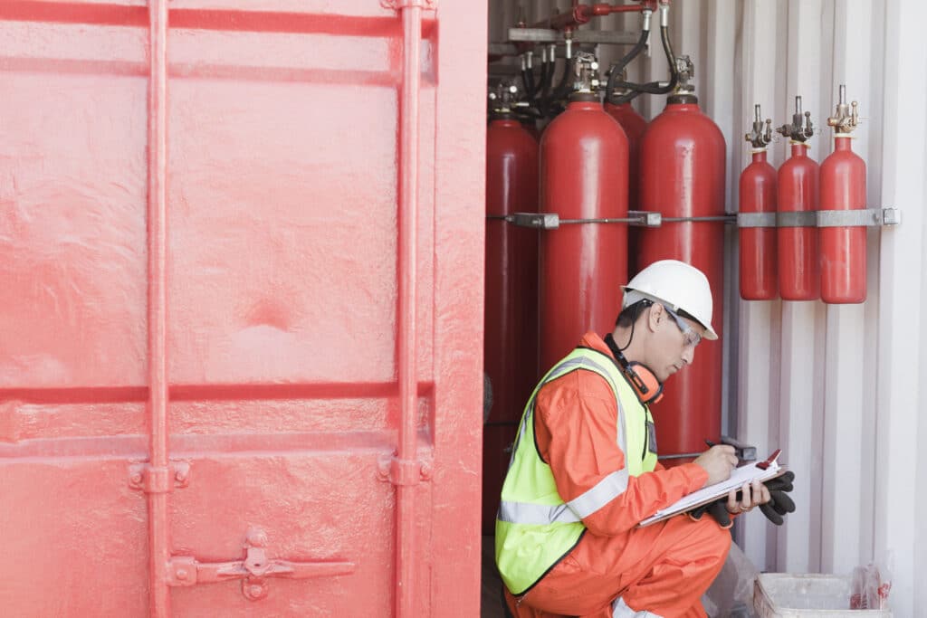 Technician inspecting fire safety equipment.