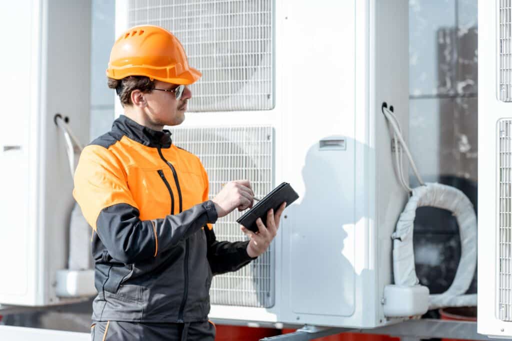 workman-servicing-air-conditioning-or-heat-pump-wi-2023-11-27-05-04-58-utc_11zon