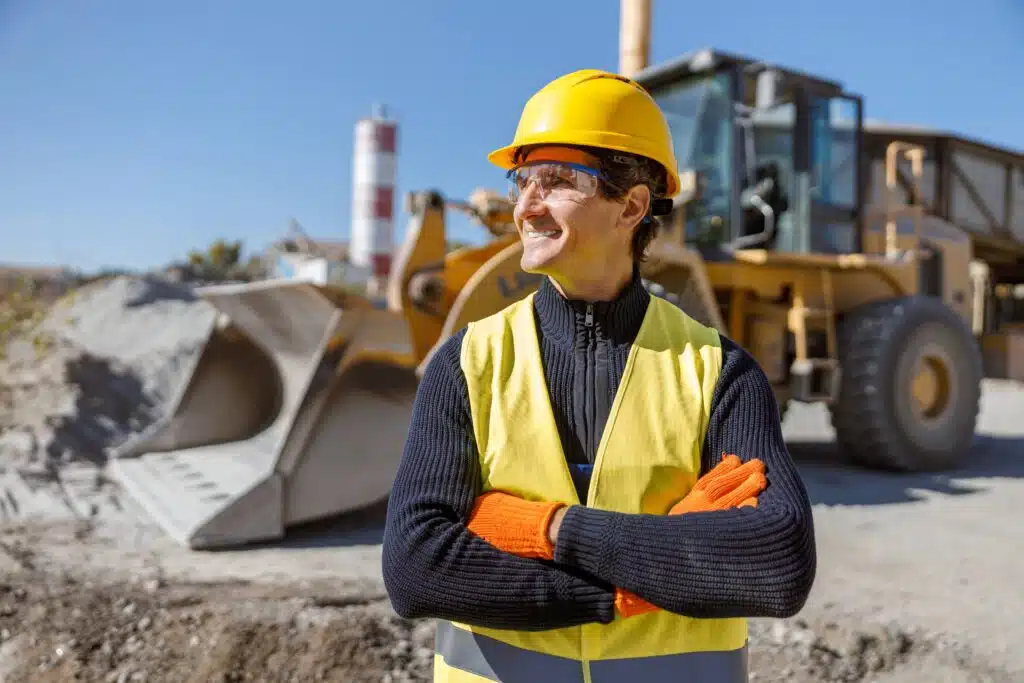 cheerful-man-factory-worker-standing-near-tractor-2023-11-27-05-21-04-utc_11zon